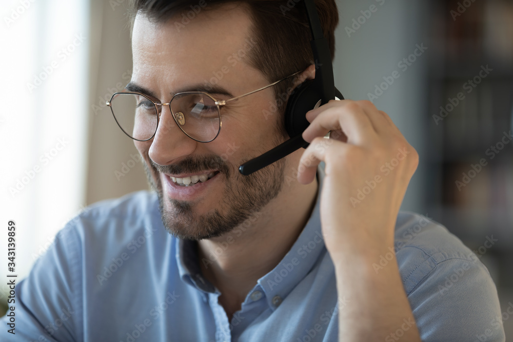 Close up smiling friendly man wearing headset talking in microphone, call center operator working, consulting client customer online, student learning language in internet, listening lecture Close up smiling friendly man wearing headset talking in microphone, call center operator working, consulting client customer online, student learning language in internet, listening lecture