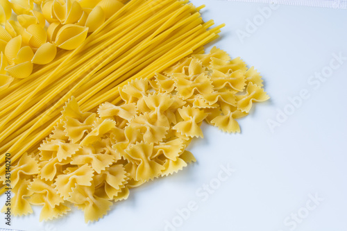 Various types of pasta on a white background