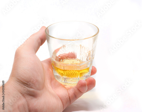 Tumbler Highball in man hand isolate on white