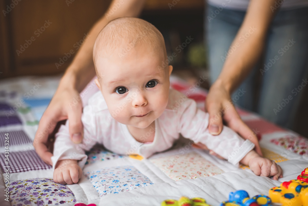portrait of baby with mother's hands portrait of baby with mother's hands