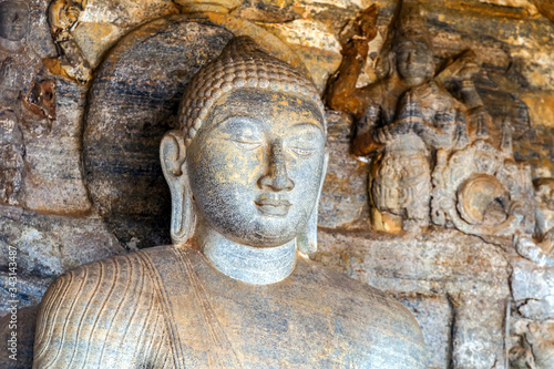 Buddha Sitting granite rock background in Gal vihara Polonnaruwa in Sri Lanka