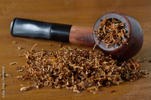 Tobacco accessories, smoking pipe and tobacco close-up. photo