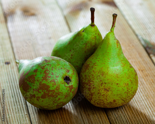 Appetizing ripe pears on a wooden table