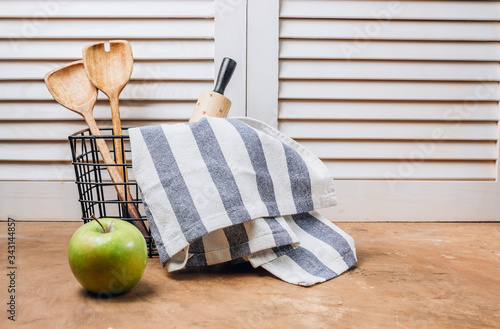 Kitchen utensils in a black basket. Home kitchen decor background with space for a text. Zero waste concept
