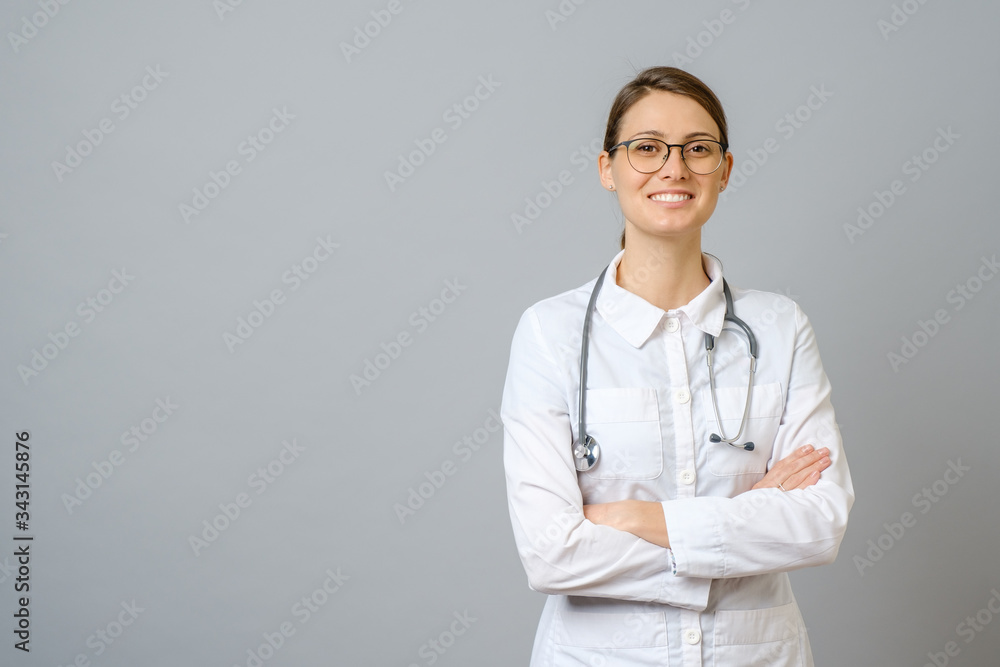 Smiling female doctor in lab coat with arms crossed Smiling female doctor in lab coat with arms crossed