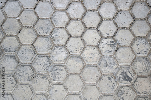 gray slabs or tiles with hexagonal shape of dirty street floor - urban background