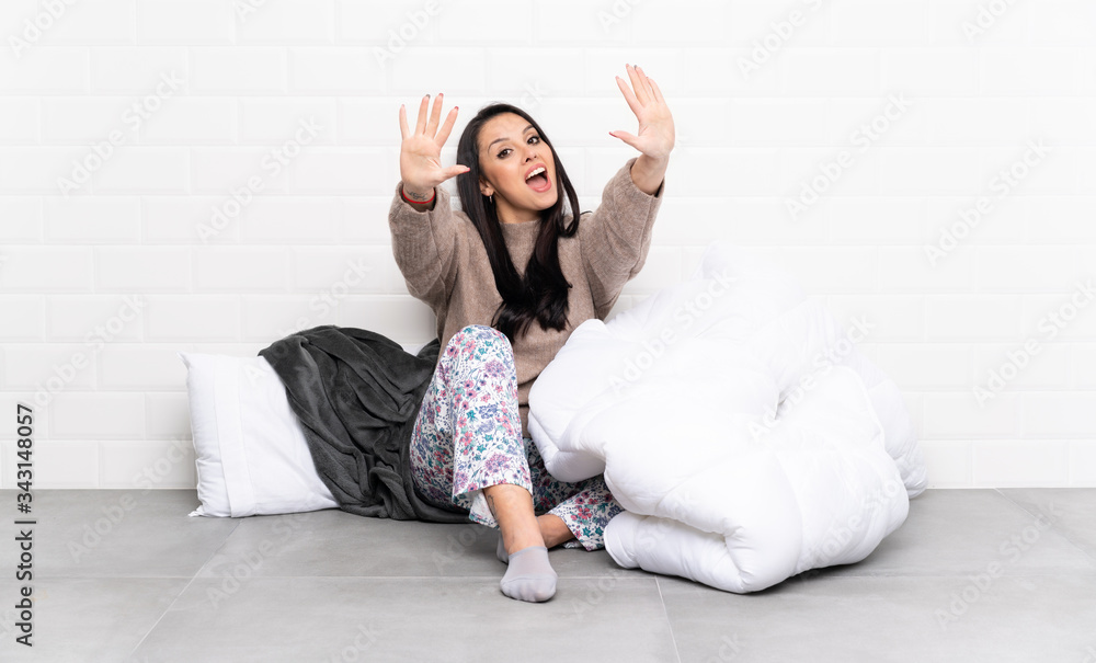 Young Colombian girl in pajamas at indoors counting ten with fingers Young Colombian girl in pajamas at indoors counting ten with fingers
