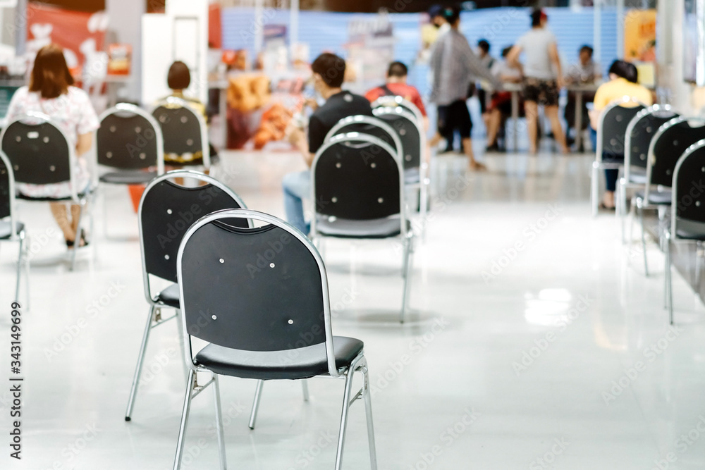 Many chairs for customers to order food and wait to take home inside of department store closed due to the corona virus (Covid-19). Restaurants set chairs for waiting for the food. Selective focus. Many chairs for customers to order food and wait to take home inside of department store closed due to the corona virus (Covid-19). Restaurants set chairs for waiting for the food. Selective focus.