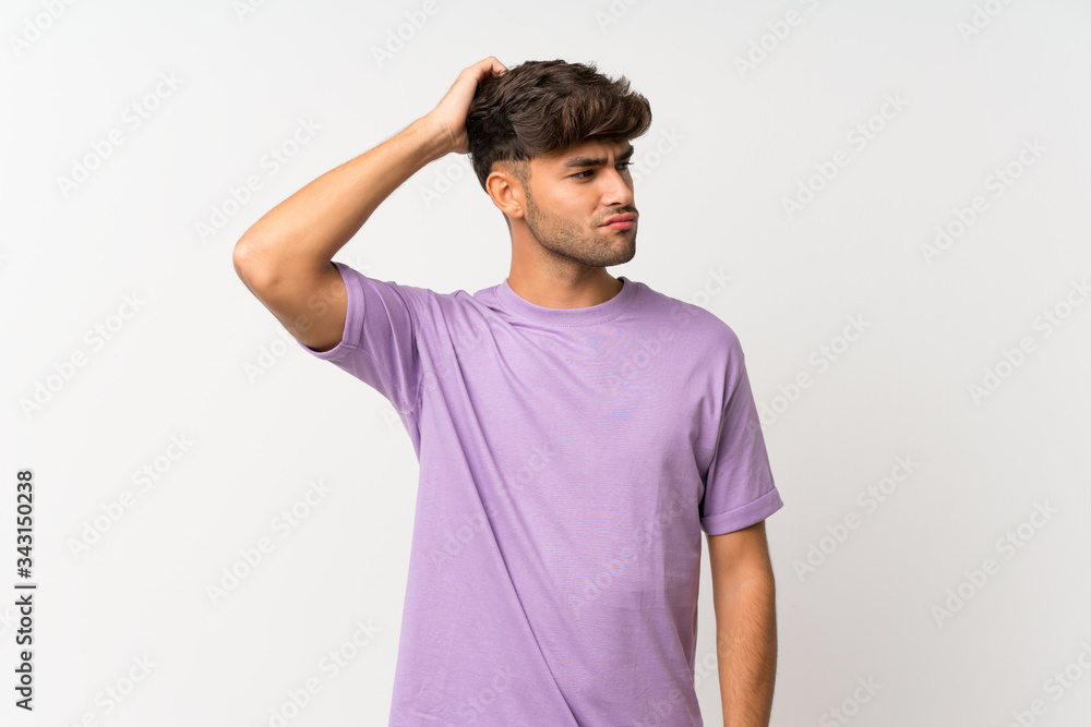 Young handsome man over isolated white background having doubts while scratching head Young handsome man over isolated white background having doubts while scratching head