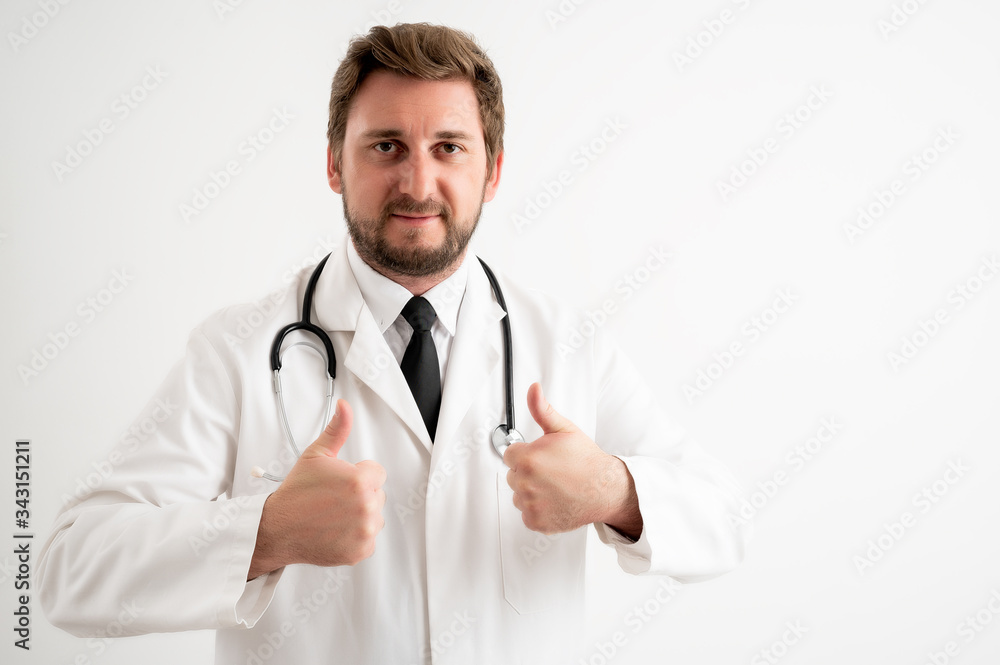 Male doctor with stethoscope, in medical uniform showing thumbs up with both hands Male doctor with stethoscope, in medical uniform showing thumbs up with both hands
