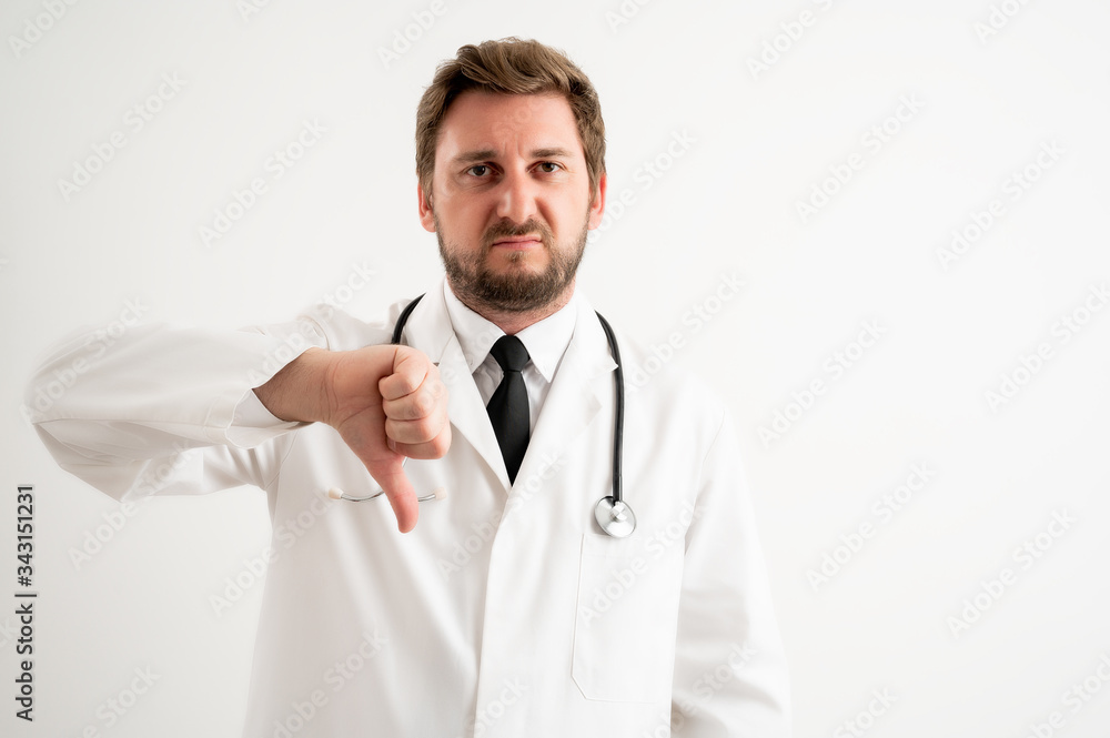 Male doctor with stethoscope in medical uniform showing showing dislike Male doctor with stethoscope in medical uniform showing showing dislike