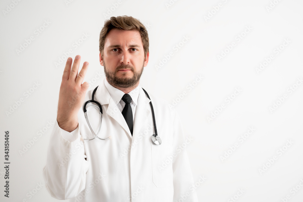 Male doctor with stethoscope in medical uniform counting three with her fingers Male doctor with stethoscope in medical uniform counting three with her fingers