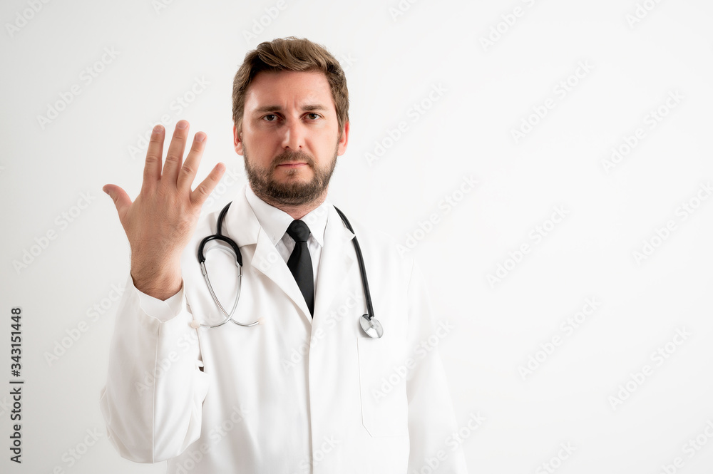 Male doctor with stethoscope in medical uniform counting five with her fingers