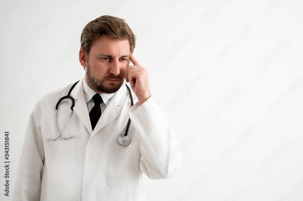 Male doctor with stethoscope in medical uniform wondering Male doctor with stethoscope in medical uniform wondering