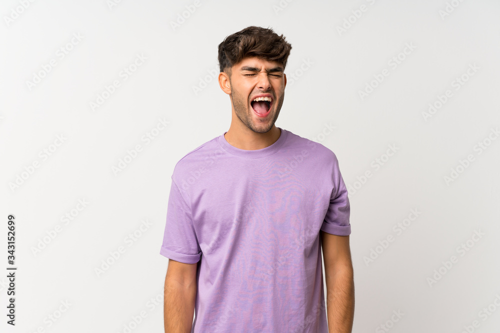 Young handsome man over isolated white background shouting to the front with mouth wide open Young handsome man over isolated white background shouting to the front with mouth wide open