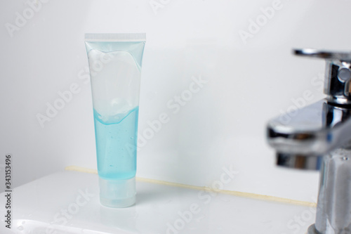 Alcohol sanitizer bottle on wash basin in toilet for disinfecting surface in a home Coronavirus and Covid-19 prevention concept.
