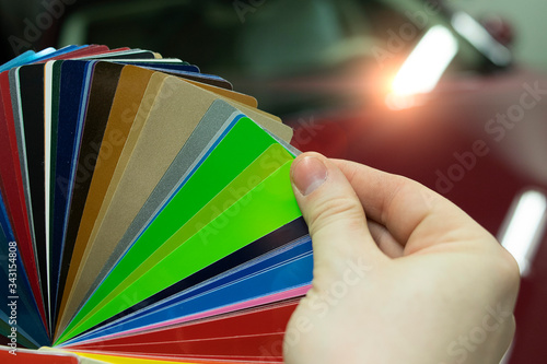 Master selects color from palette of vinyl films swatches for car wrapping