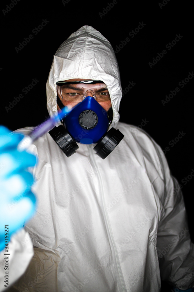 Close up portrait image of a health worker wearing protective clothing and masks working with Vaccines for dangerous viruses Close up portrait image of a health worker wearing protective clothing and masks working with Vaccines for dangerous viruses