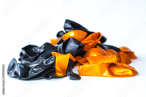 Black and orange balloons on a white scene