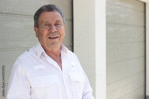 Portrait of a smiling senior man feeling great, looking at camera