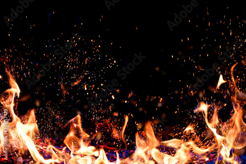 Fotomurale Flames of fire on a dark background. Copy space, place for text.