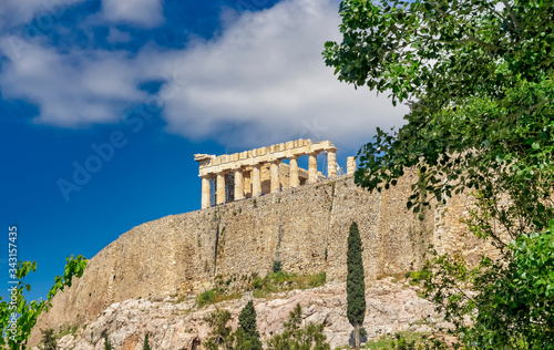 Athens Greece, parthenon temple on acropolis hilll and vibrant greeen foliage