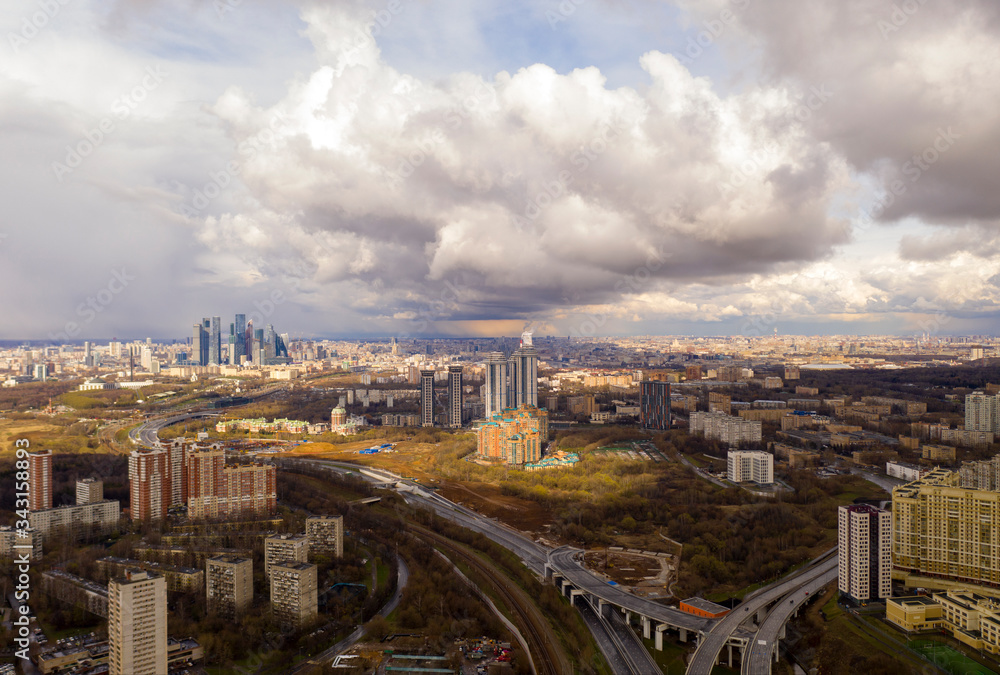 Fototapeta premium industrial views of a big city at sunset filmed from a drone