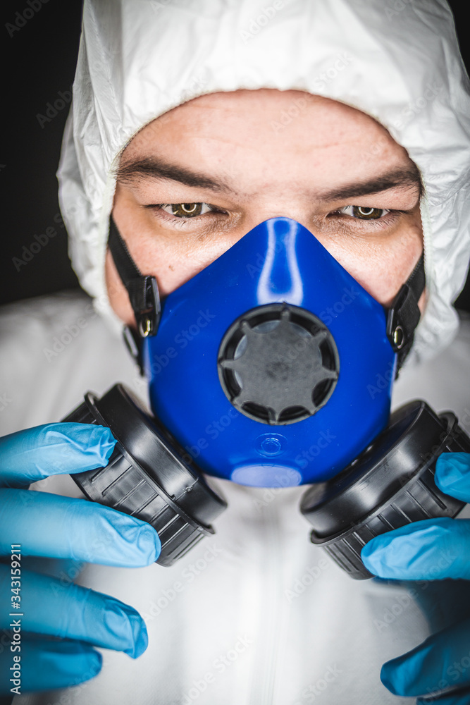 Close up portrait image of a health worker wearing protective clothing and masks working with Vaccines for dangerous viruses Close up portrait image of a health worker wearing protective clothing and masks working with Vaccines for dangerous viruses