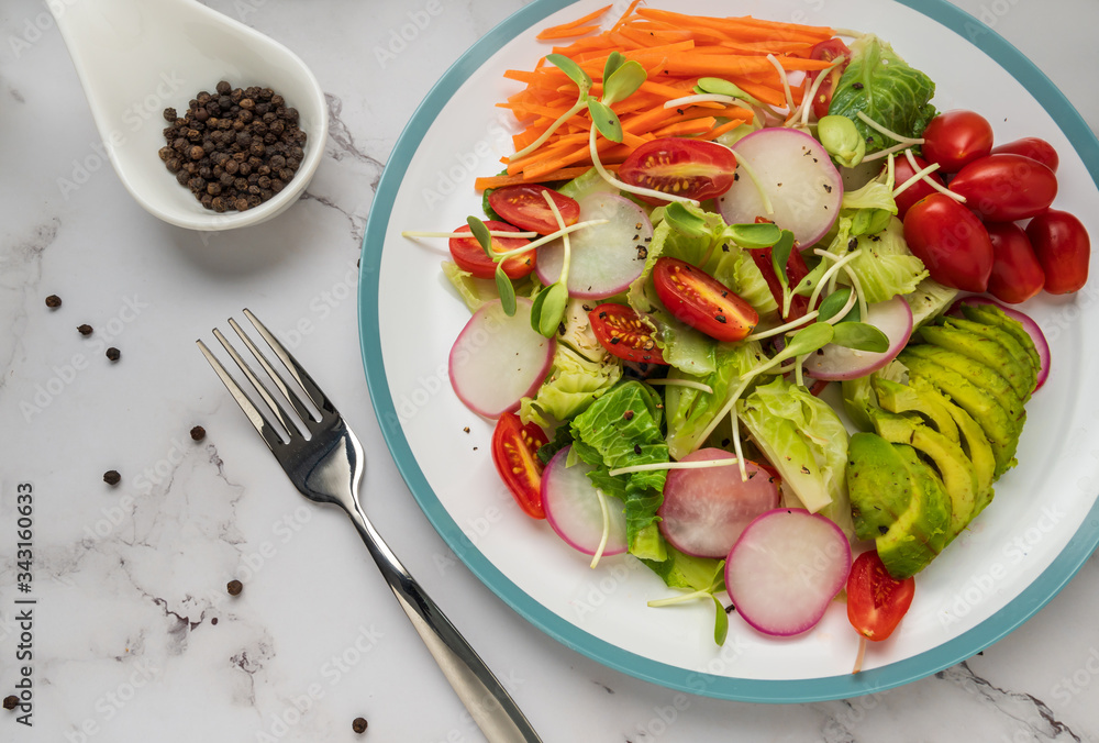healthy vegan bowl. Avocado, tomato, Red Radish,carrot, Sunflower seedling,Black pepper, lemon, and vegetables salad. Top view. vegan food, clean eating, dieting healthy vegan bowl. Avocado, tomato, Red Radish,carrot, Sunflower seedling,Black pepper, lemon, and vegetables salad. Top view. vegan food, clean eating, dieting