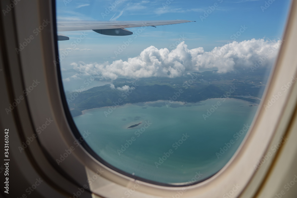 Fototapeta premium View from the window of the airplane on the wing, sky and clouds.