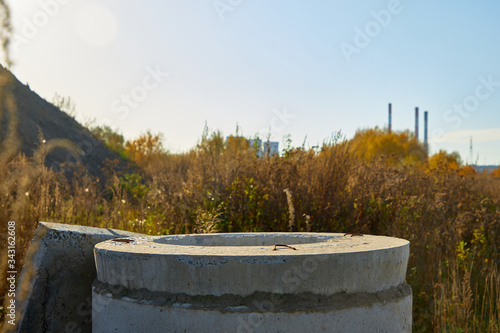 Close-up of a concrete well in the grass © Volodya