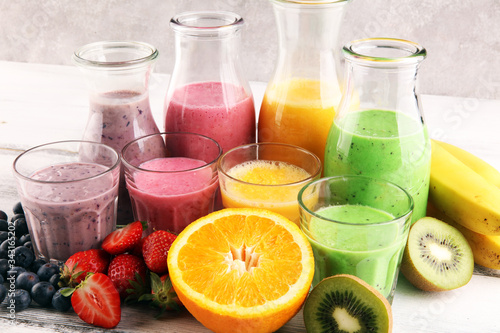 Assortment of fruit smoothies in glass bottles. Fresh organic Smoothie ingredients. Smoothies for health or detox diet food