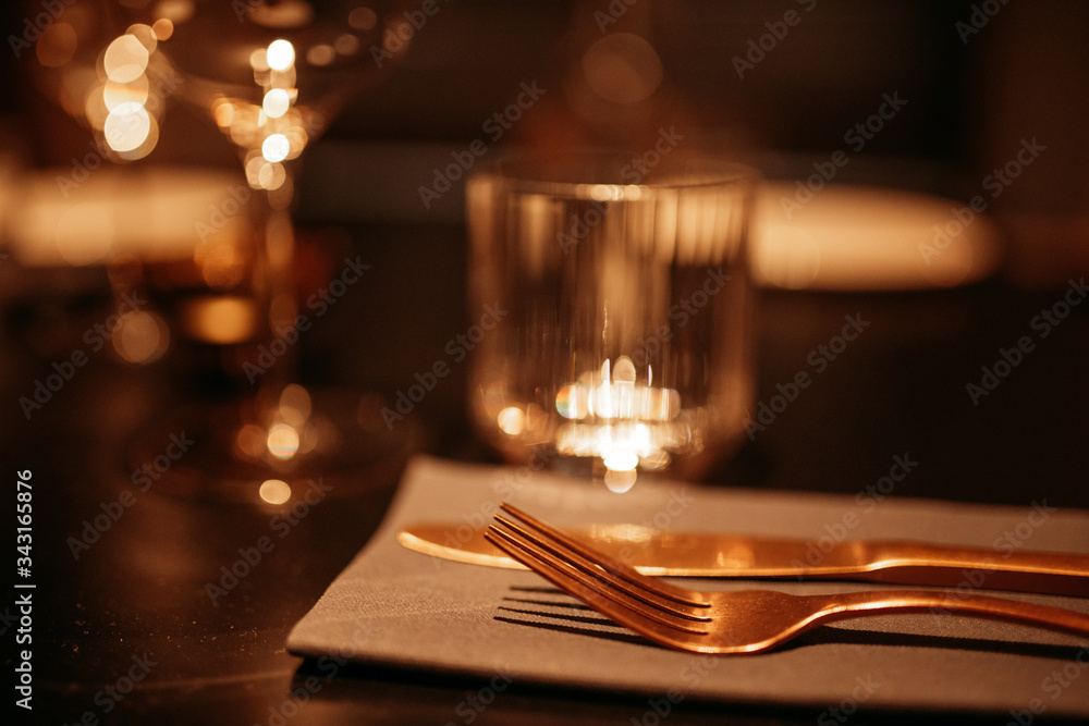 blurred tеable setting in a restaurant. Fork close up, warm brown tinted