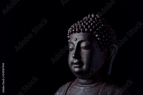 Meditating Buddha Statue isolated on black background. Copy space.  © Eugeniusz Dudziński