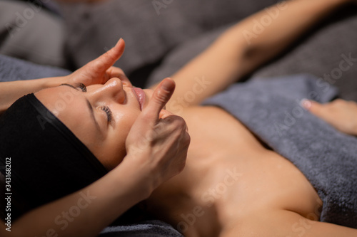 beautiful caucasian women get skin treatment, face lift by professional masseurs in wellness beauty salon. attractive ladies are pampered at the health spa