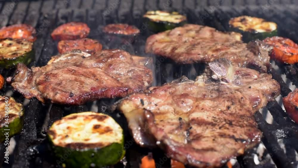 Meat and vegetables cooking on a barbecue Meat and vegetables cooking on a barbecue