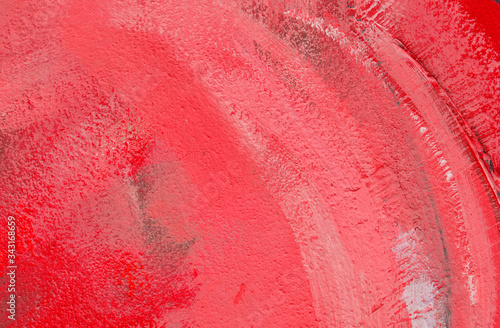 Red background. Wall covered with old cracked stucco, pink tinted. Bright neon backdrop. Modern urban industrial concept. Copy space. Selective focus image.