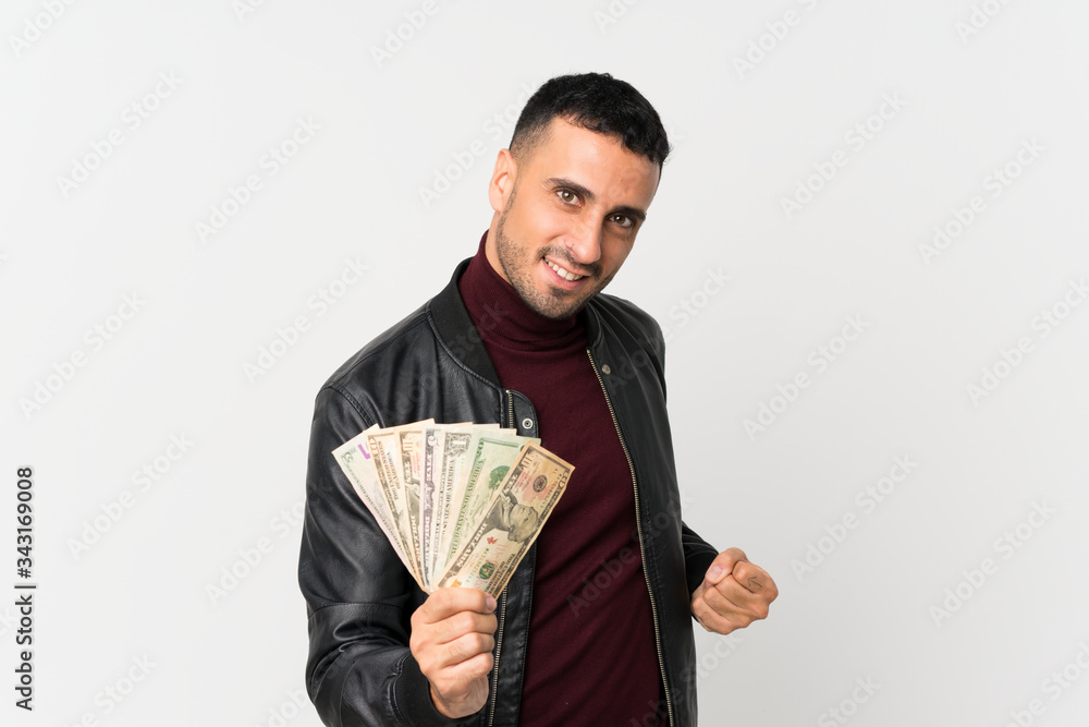 Young man over isolated white background taking a lot of money Young man over isolated white background taking a lot of money