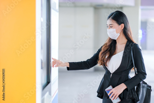 Free Download Beautiful business woman with hygiene mask point to sky train or transportation map at the station to select the destination of working during Covid-19 pandemic in city. - GFXLoad