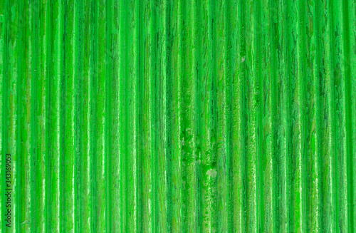 Bright green wooden background, boards. Green tinted wood. Fragment of fence, floor or wall of building made of wooden boards, place for text. Copy space.