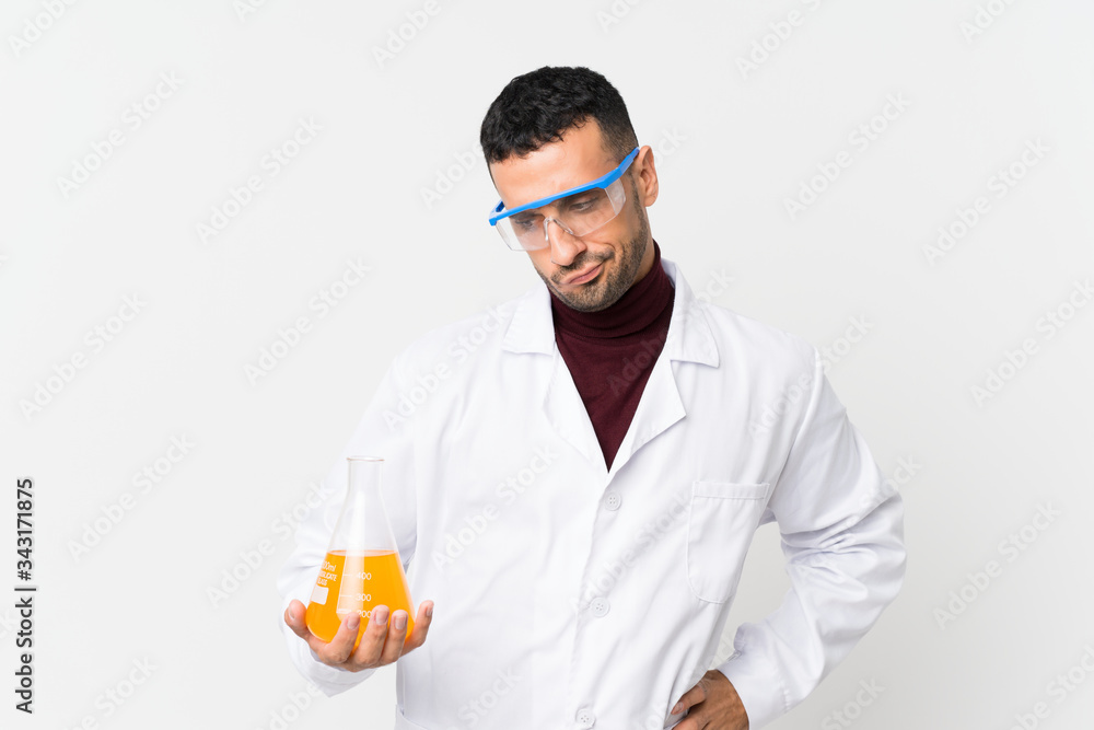 Young man over isolated white background with a scientific test tube Young man over isolated white background with a scientific test tube