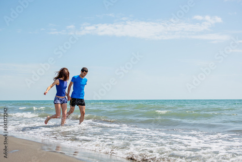 Young happy couple on seashore © blicsejo