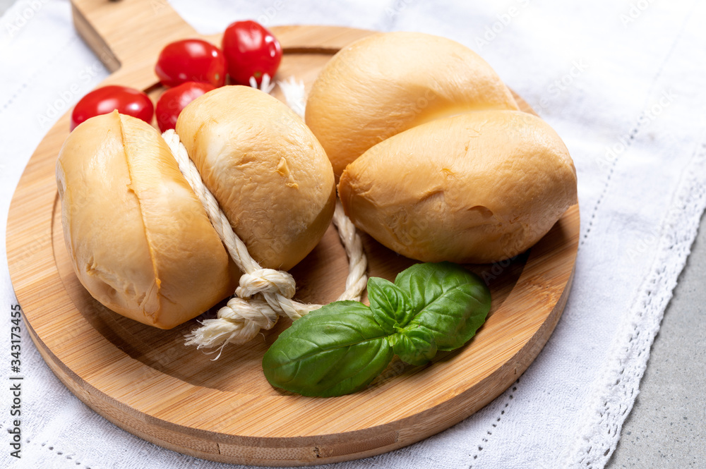 Italian semi hard handmade smoked scamorza cheese, from cow milk from Apulia or Calabria regions Italian semi hard handmade smoked scamorza cheese, from cow milk from Apulia or Calabria regions