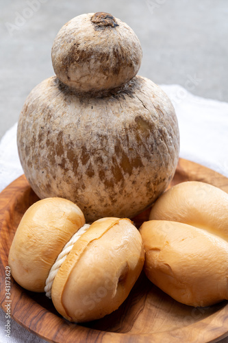 Italian semi hard handmade smoked scamorza and caciocavallo matured in caves cheeses made from cow milk from Apulia or Calabria regions photo