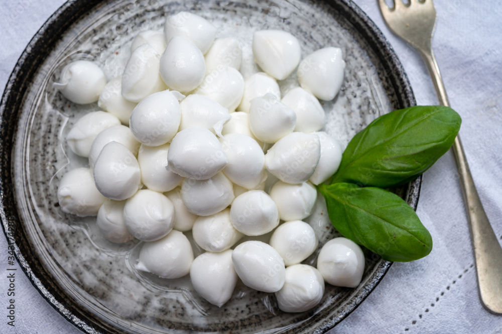Italian food, fresh fresh green basil and white mini mozzarella soft balls cheese Italian food, fresh fresh green basil and white mini mozzarella soft balls cheese