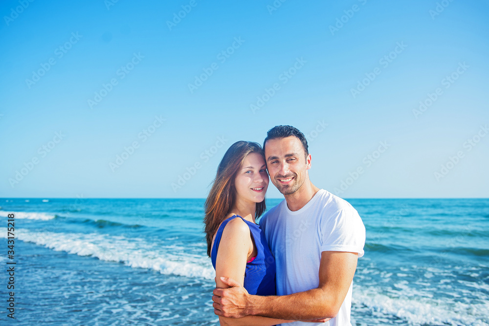 Young happy couple on seashore Young happy couple on seashore