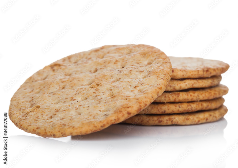 Stack of round organic crispy wheat flatbread salty crackers on white. Stack of round organic crispy wheat flatbread salty crackers on white.