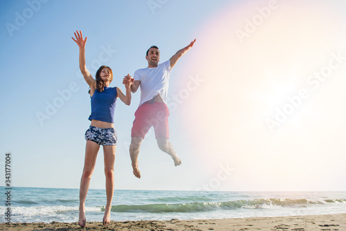 Young happy couple on seashore 