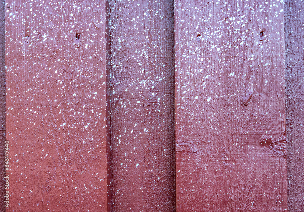 Fototapeta premium Close up view at multiple small white spots of white paint accidentally sprayed at red weooden wall.