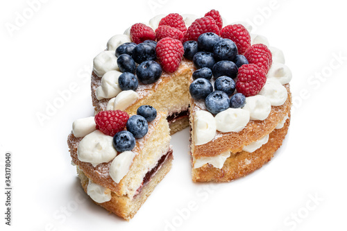 Canvas Print Victoria sponge cake with whipped cream and berries on top isolated on white
